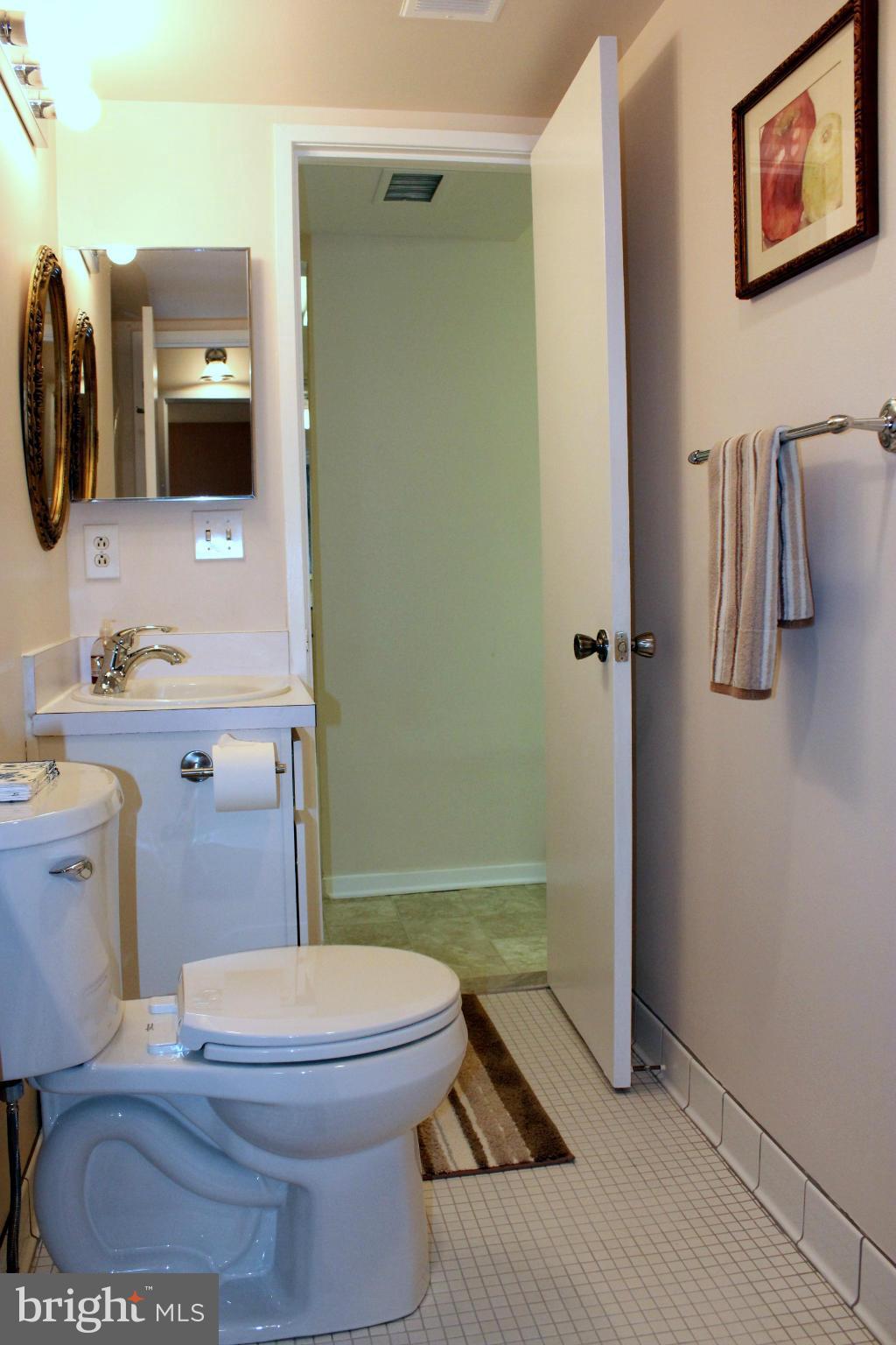 5643 Harpers Farm Road, Unit A Columbia, MD 21044 - Photo 20 of 25 a bathroom with a toilet a sink and shower