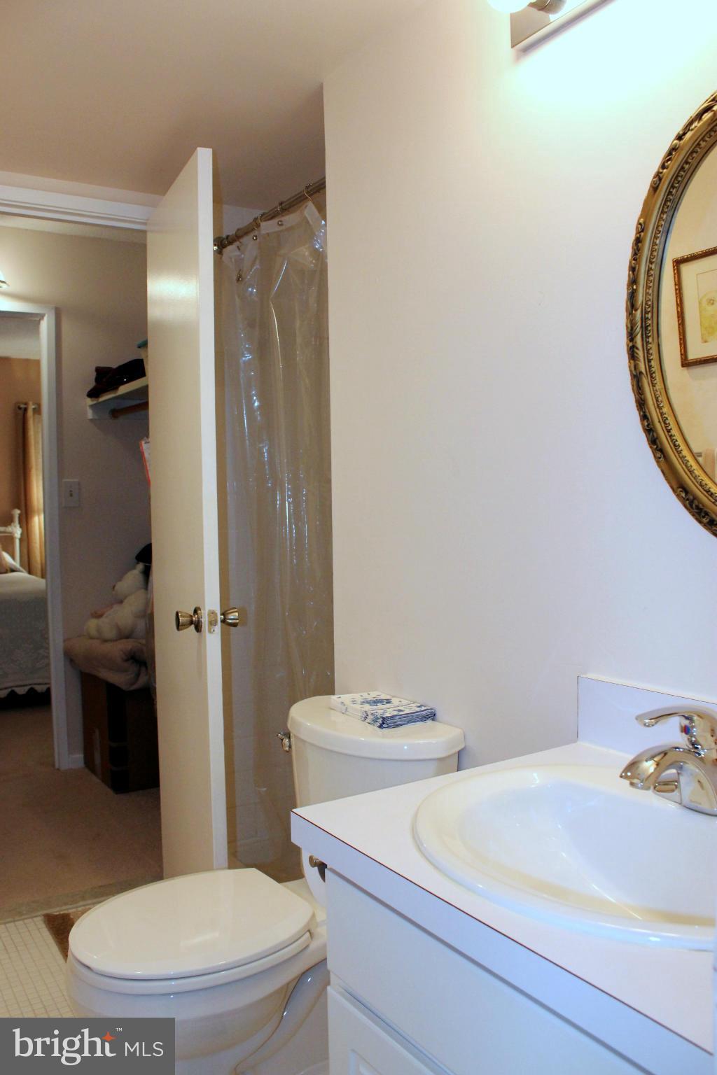 5643 Harpers Farm Road, Unit A Columbia, MD 21044 - Photo 21 of 25 a bathroom with a sink a toilet and shower