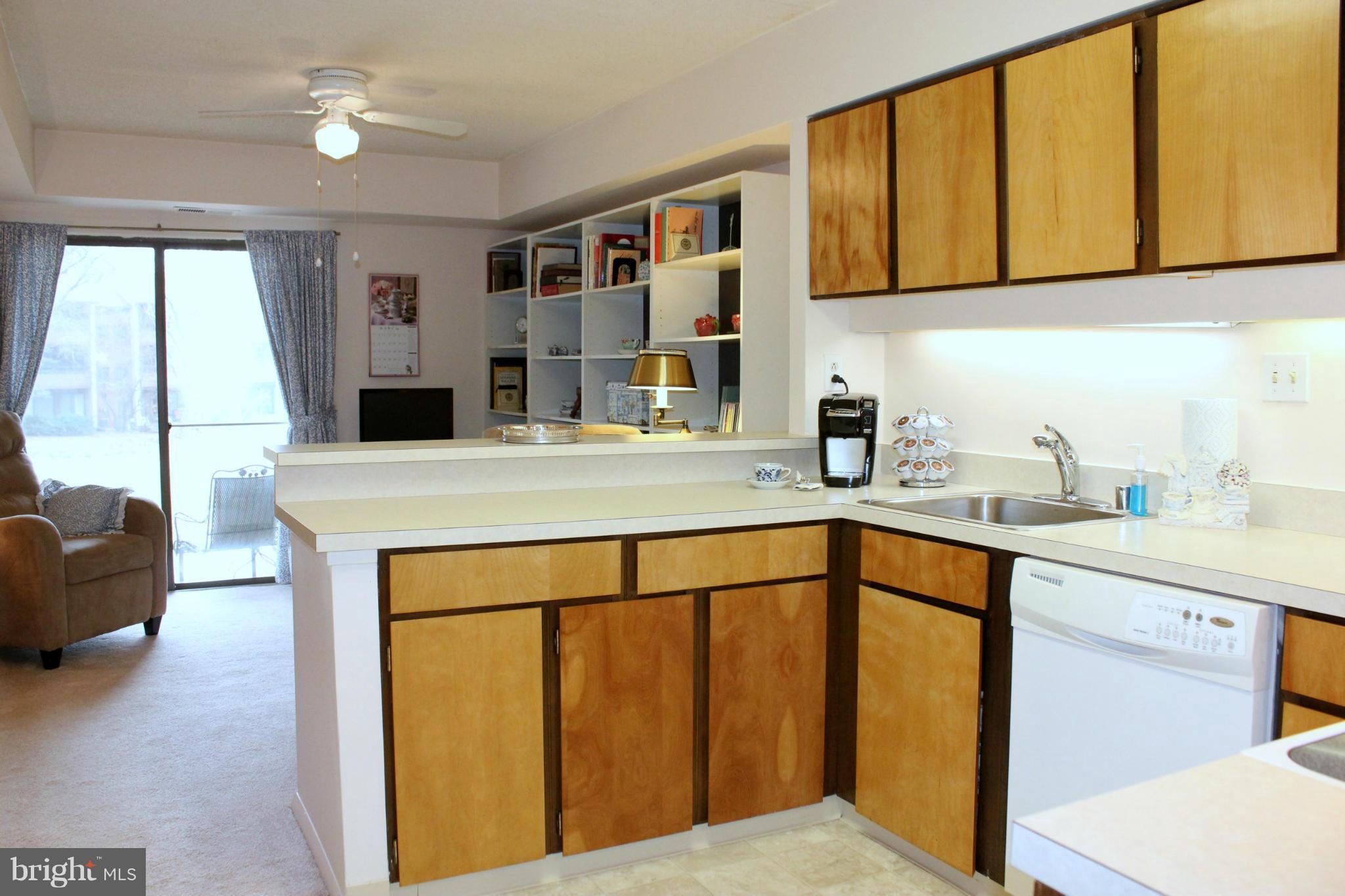 5643 Harpers Farm Road, Unit A Columbia, MD 21044 - Photo 4 of 25 a kitchen with a sink cabinets and a window