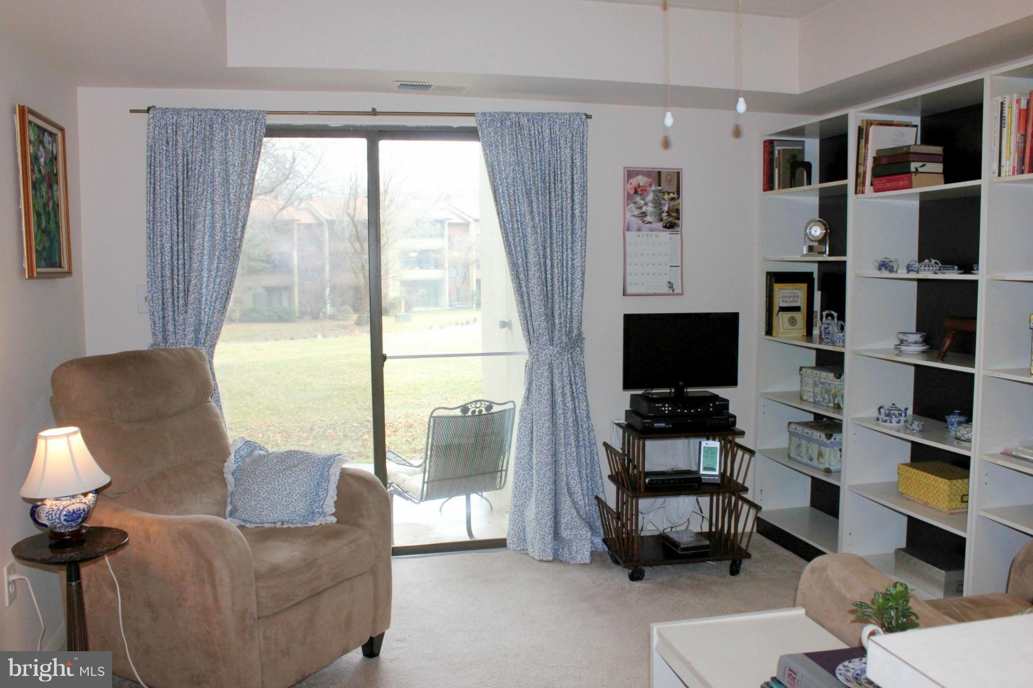 5643 Harpers Farm Road, Unit A Columbia, MD 21044 - Photo 9 of 25 a living room with furniture and a flat screen tv