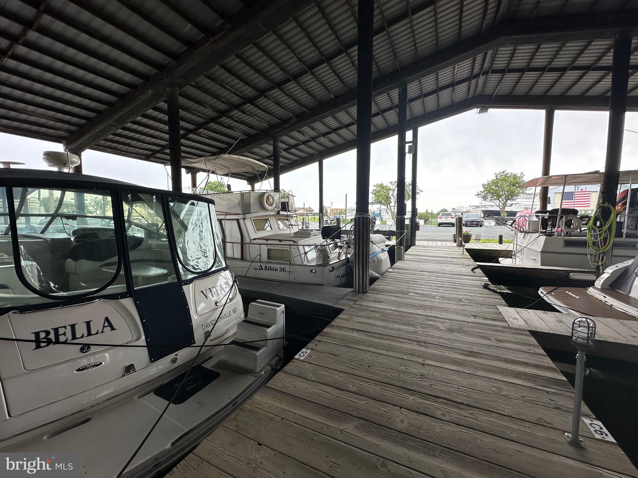 5 Piney Narrows Road Chester, MD 21619 - Photo 2 of 22 a view of a patio with wooden floor a barbeque grill with a table and chairs