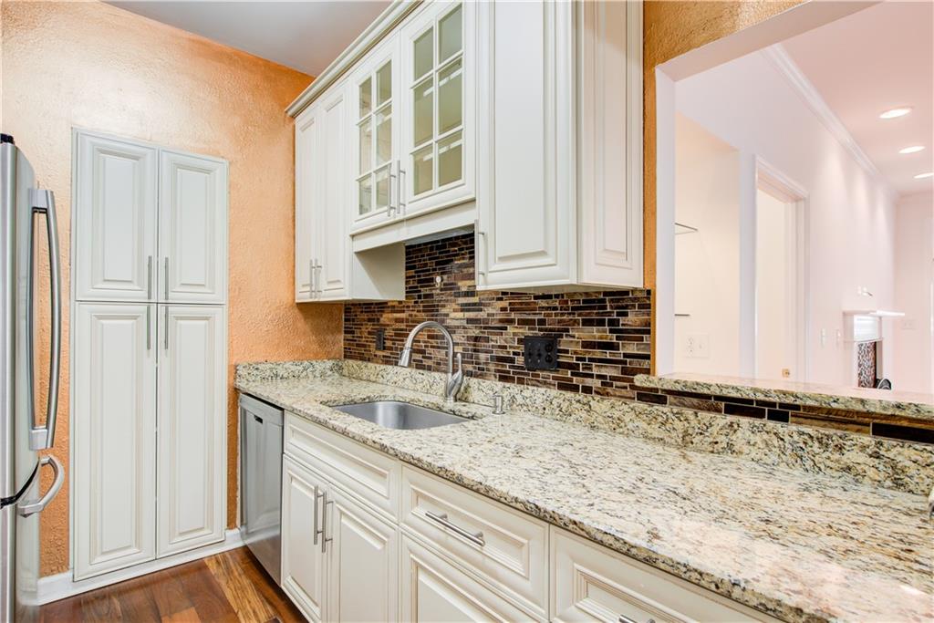2865 Lenox Road Northeast, Unit 102 Atlanta, GA 30324 - Photo 7 of 35 a kitchen with granite countertop a sink and a stove