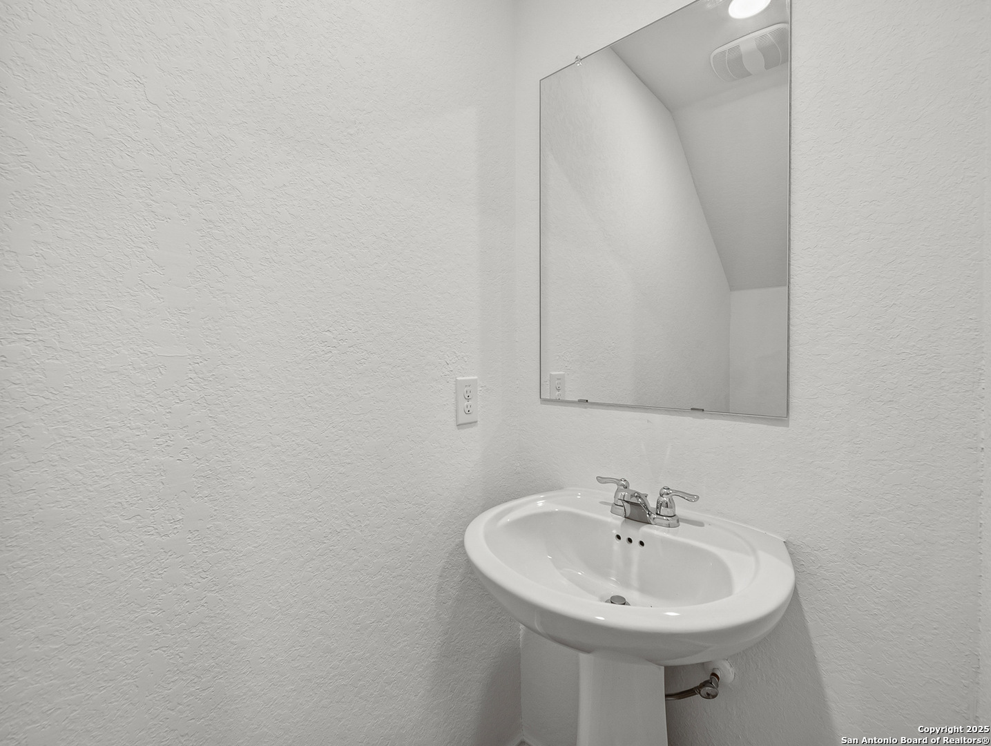 8842 Barrow Path Converse, TX 78109 - Photo 14 of 36 a bathroom with a sink and a mirror