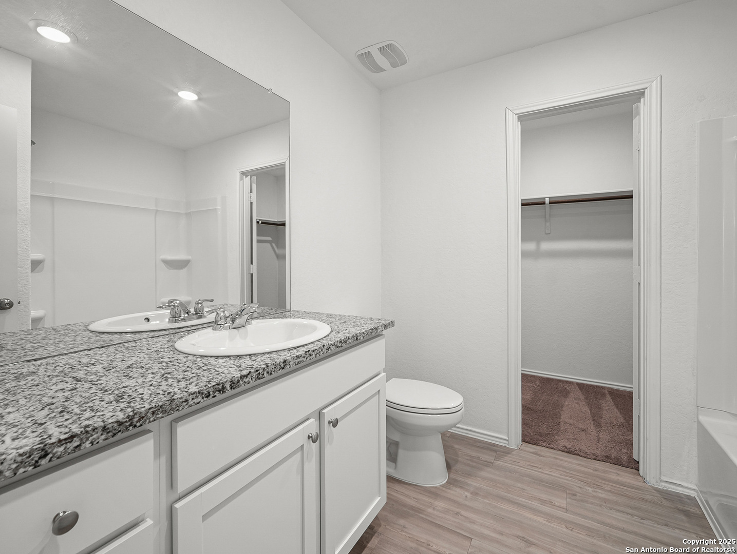 8842 Barrow Path Converse, TX 78109 - Photo 22 of 36 a bathroom with a granite countertop sink a toilet and a mirror