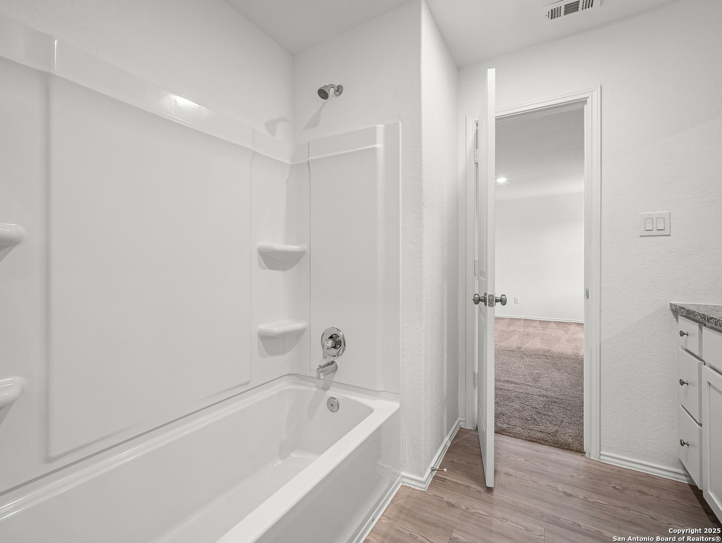 8842 Barrow Path Converse, TX 78109 - Photo 23 of 36 a bathroom with a tub shower and vanity