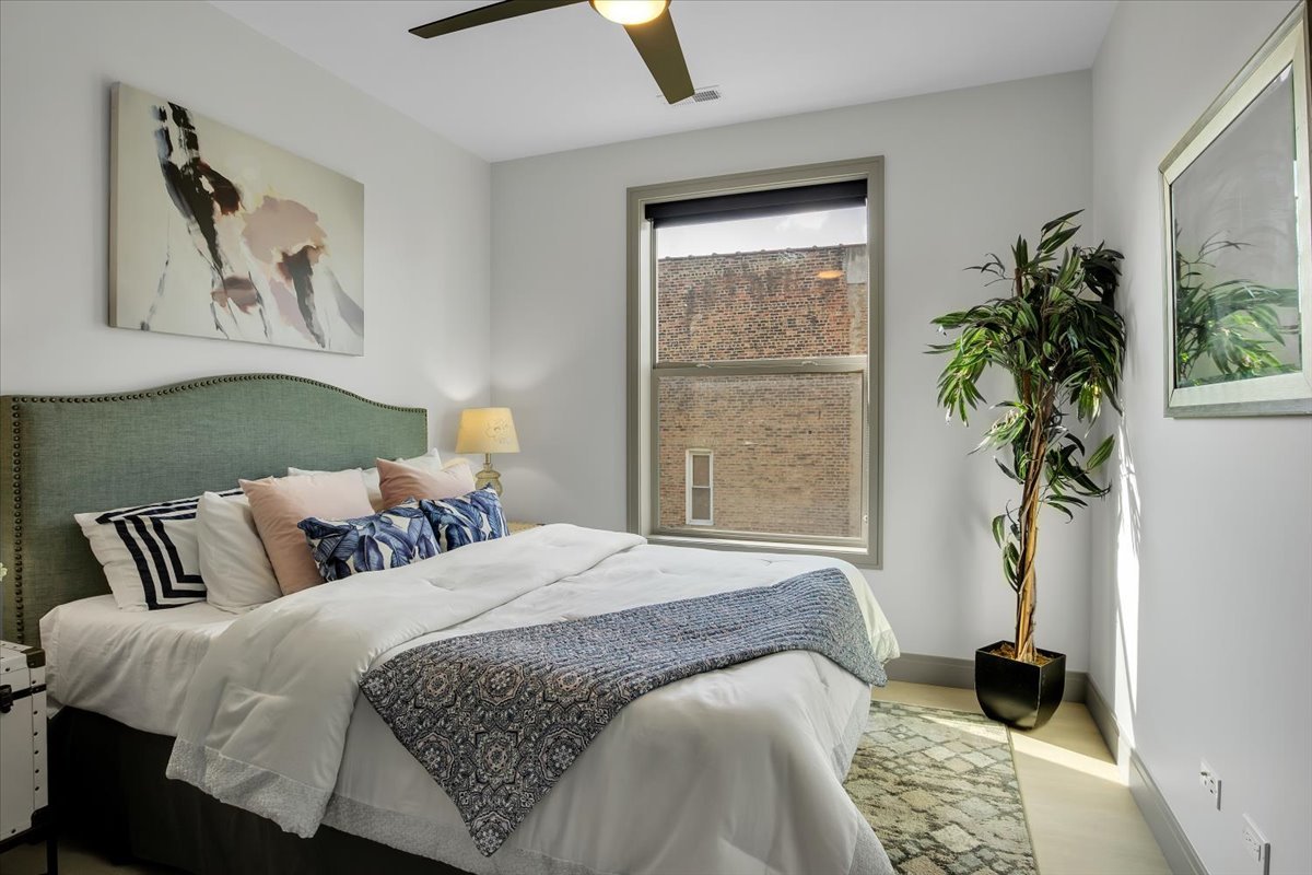 4235 South Champlain Avenue, Unit 2S Chicago, IL 60653 - Photo 17 of 26 a bedroom with a bed and a window