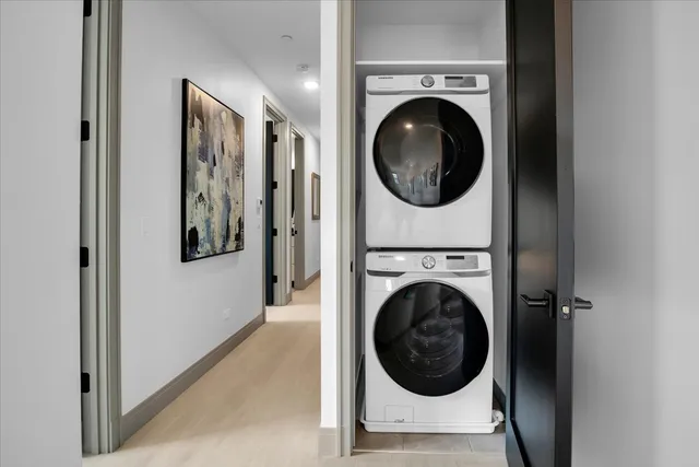 a view of a hallway with washer and dryer