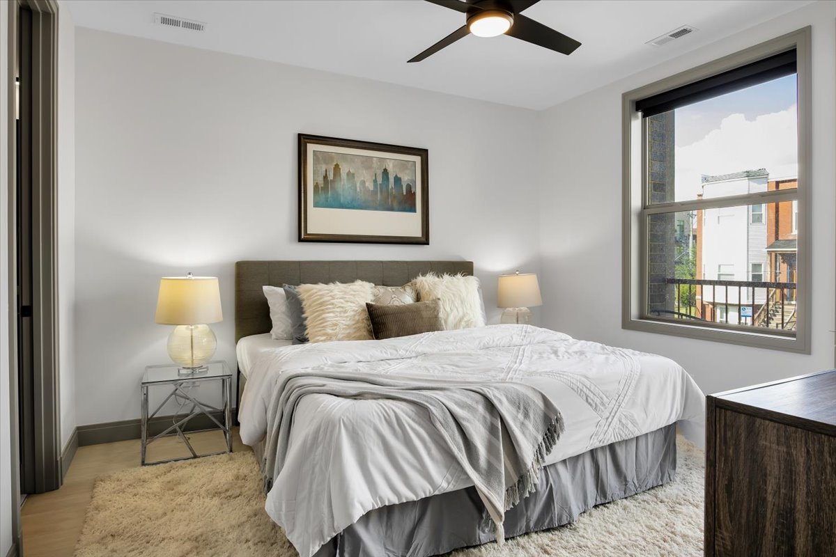 4235 South Champlain Avenue, Unit 2S Chicago, IL 60653 - Photo 8 of 26 a bedroom with bed and window