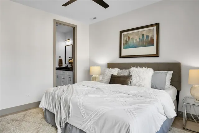 a bedroom with bed and painting on the wall