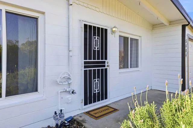 a front view of a house with a garden