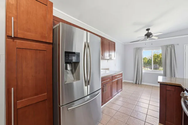 a kitchen with stainless steel appliances granite countertop a refrigerator and a sink