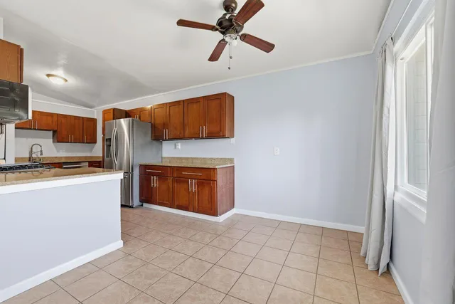 a kitchen with stainless steel appliances a refrigerator and a stove top oven