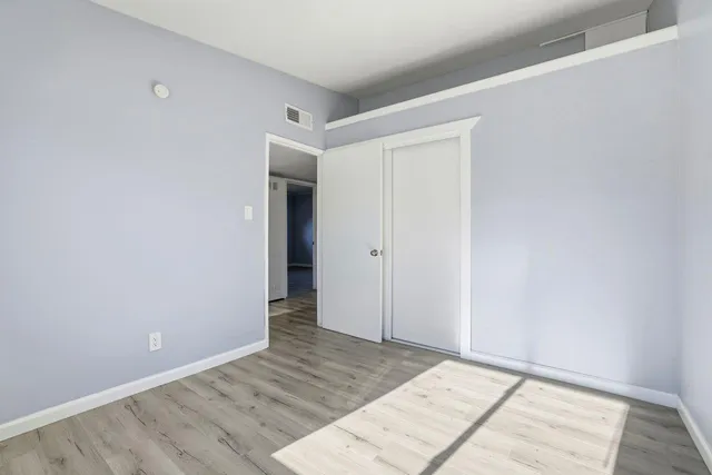 an empty room with wooden floor