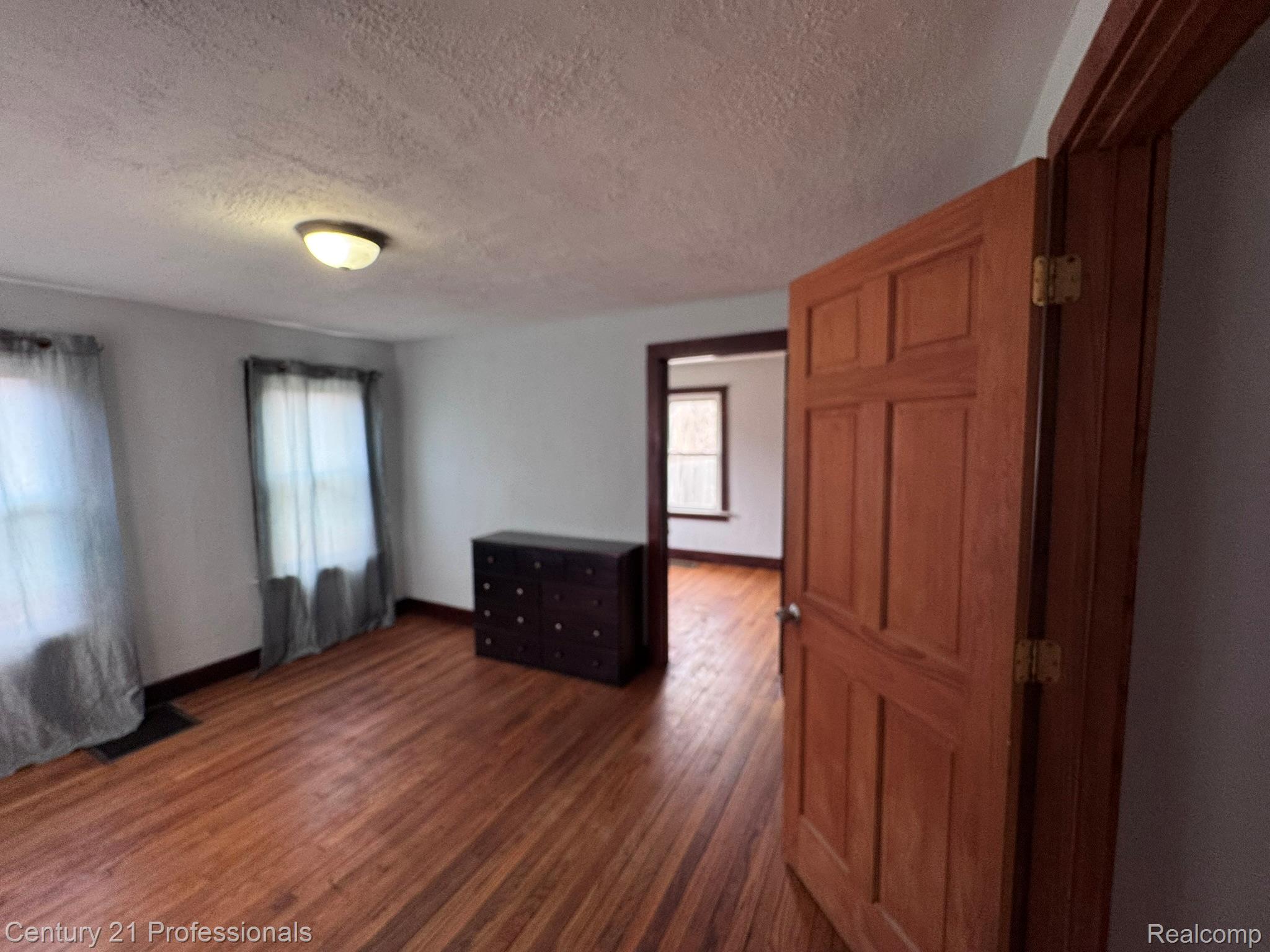 2021 West Rose Center Road Holly, MI 48442 - Photo 23 of 30 Empty room with dark wood-style floors and a textured ceiling