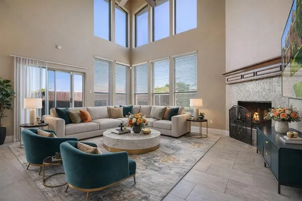 a view of an empty room with a fireplace and a window