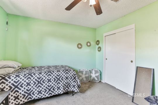 604 South Lakeview Court Ridgecrest, CA 93555 - Photo 14 of 29 a bedroom with a bed and a dresser