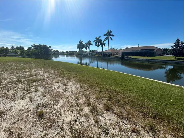 a view of a lake with houses in the back