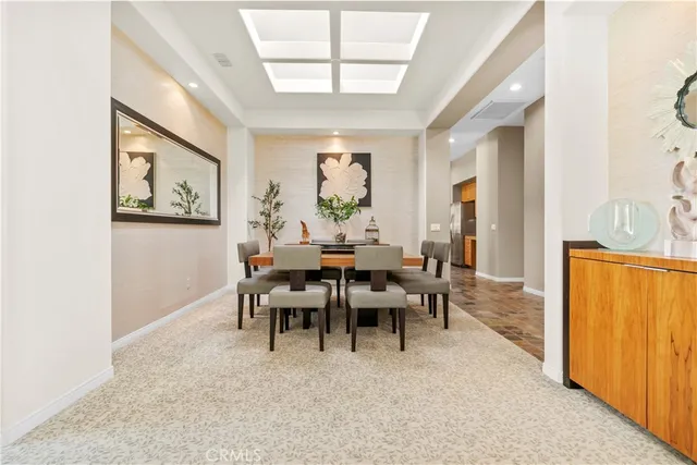 a kitchen with a table chairs sink and cabinets