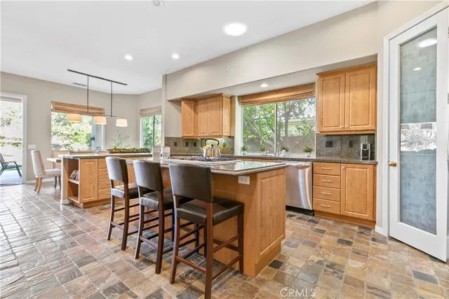 a kitchen with stainless steel appliances granite countertop a stove and a sink