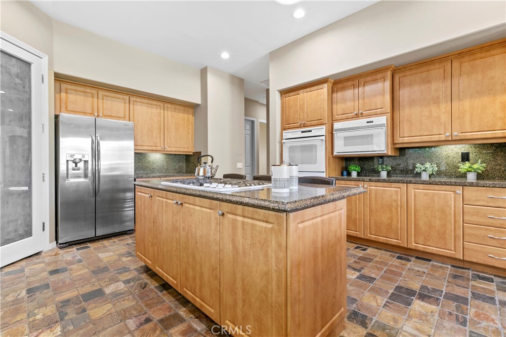 44 Killian Way Rancho Mirage, CA 92270 - Photo 14 of 72 a kitchen with stainless steel appliances granite countertop a refrigerator sink and cabinets