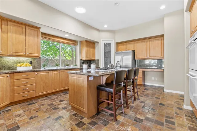 a kitchen with a cabinets a sink a counter top space and stainless steel appliances