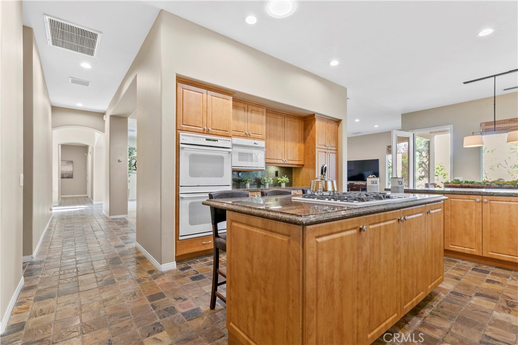 44 Killian Way Rancho Mirage, CA 92270 - Photo 15 of 72 a kitchen with stainless steel appliances granite countertop a stove and a sink