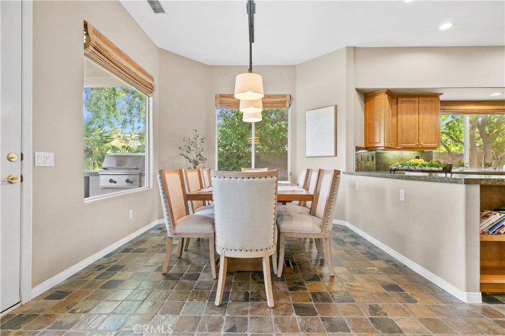 44 Killian Way Rancho Mirage, CA 92270 - Photo 17 of 72 a dining room with furniture a chandelier and wooden floor