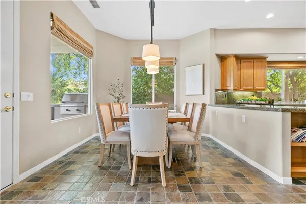 a view of a hallway with a dining area and entryway