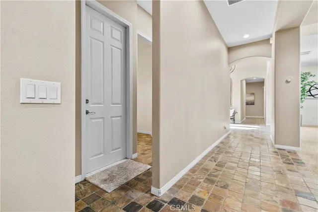 a view of a bedroom with furniture and window