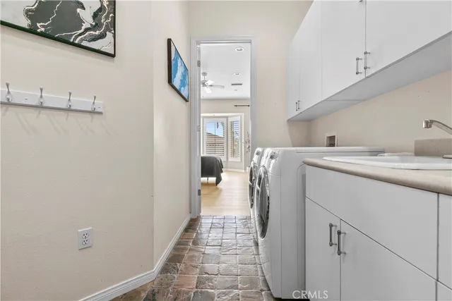 a view of a hallway with wooden floor and a bathroom