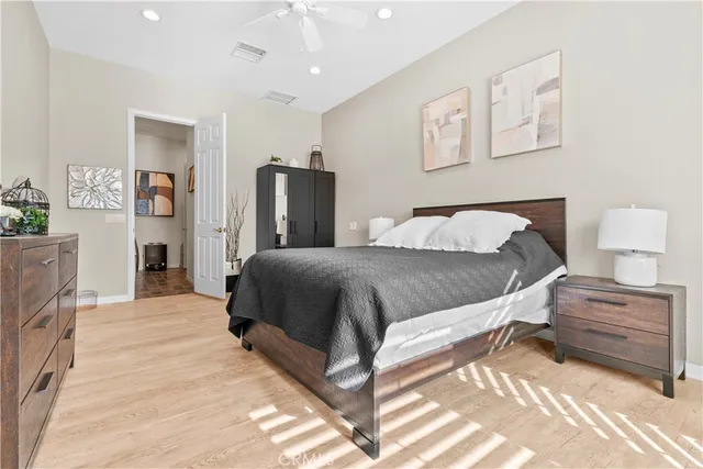 a spacious bedroom with a bed and a chandelier