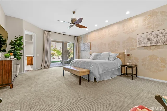 a spacious bedroom with a bed and a large window