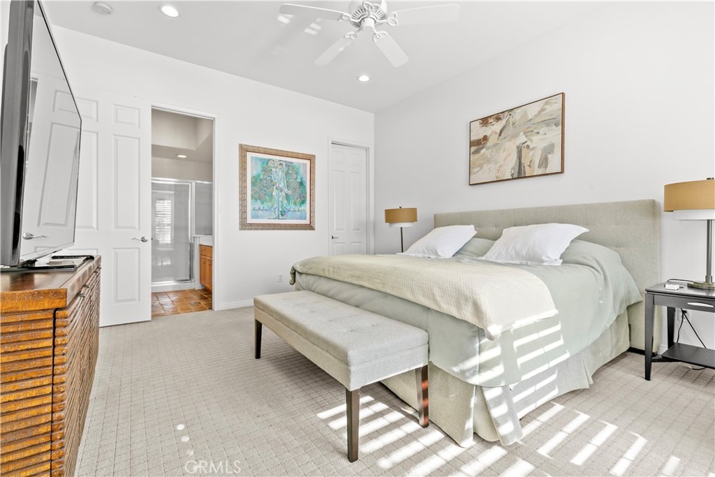 44 Killian Way Rancho Mirage, CA 92270 - Photo 47 of 72 a spacious bedroom with a bed and a chandelier