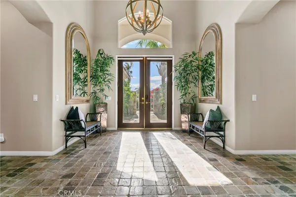 a living room with furniture and large windows
