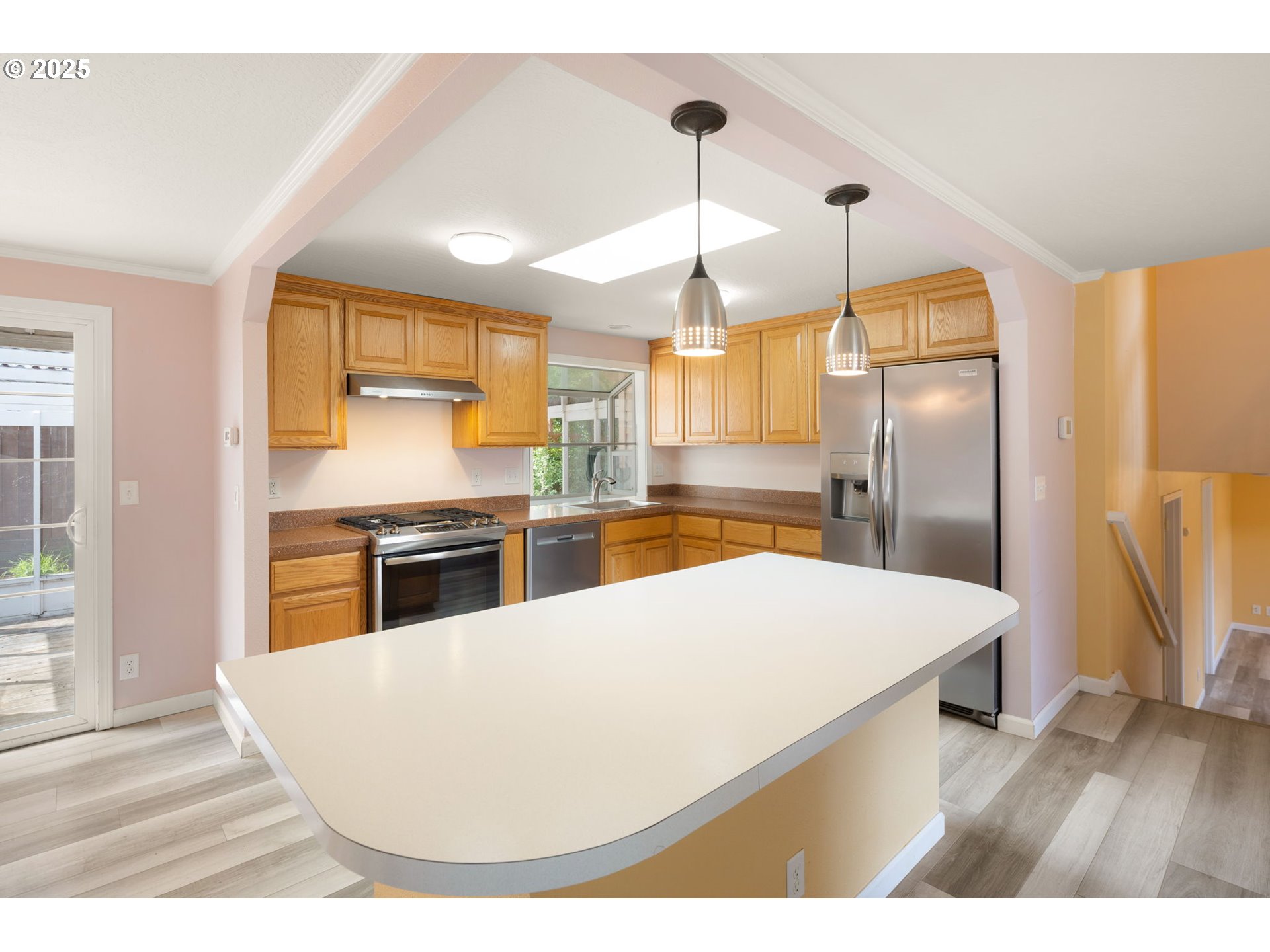 2730 Malibu Way Eugene, OR 97405 - Photo 12 of 47 a kitchen with stainless steel appliances kitchen island a refrigerator sink and cabinets