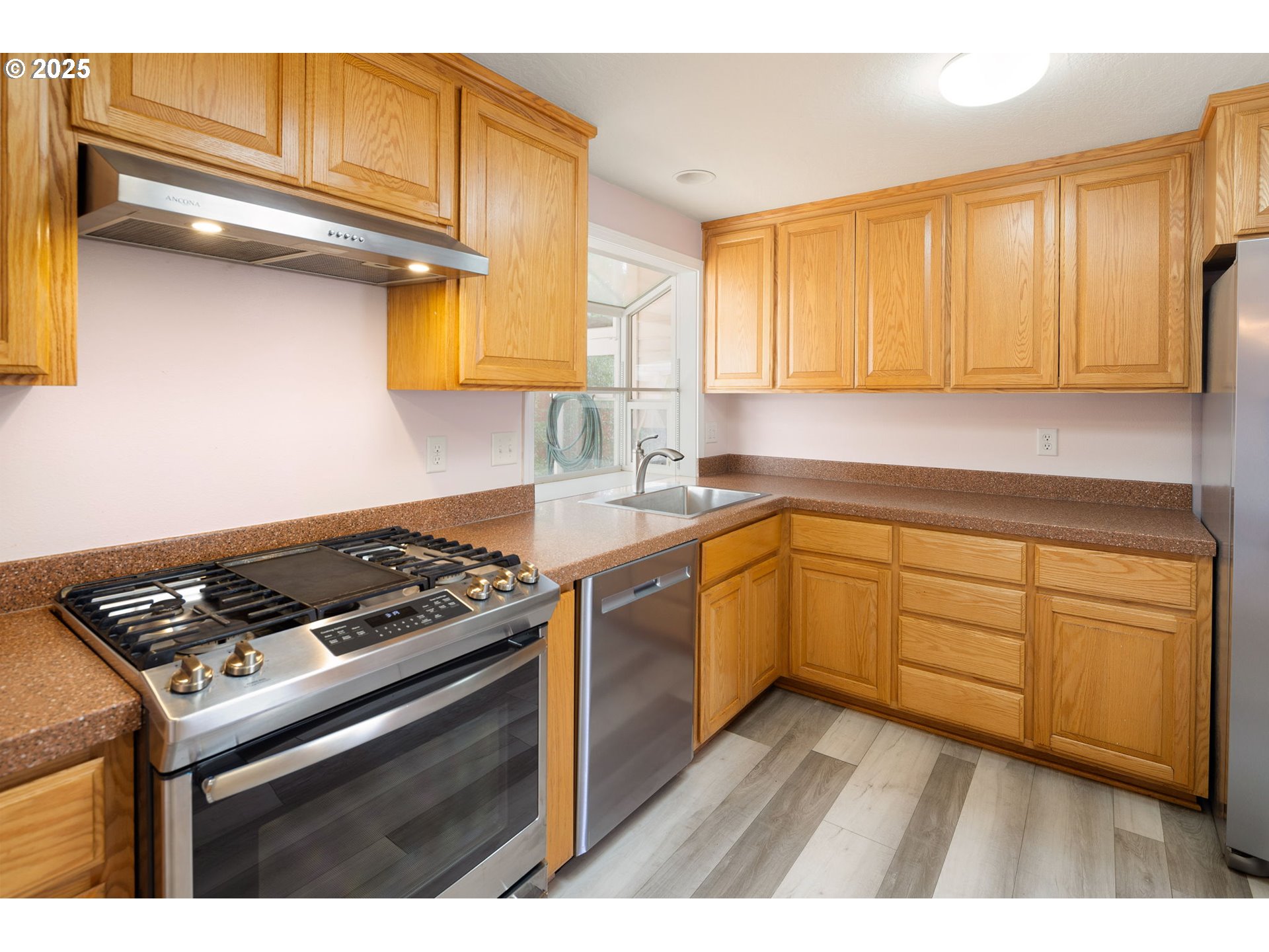 2730 Malibu Way Eugene, OR 97405 - Photo 13 of 47 a kitchen with cabinets appliances and a window