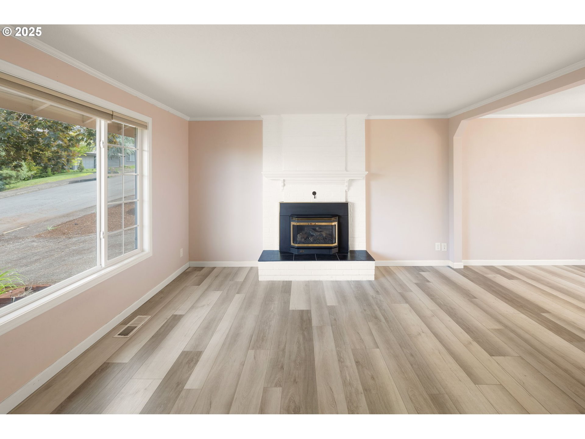 2730 Malibu Way Eugene, OR 97405 - Photo 7 of 47 a view of empty room with a fireplace and wooden floor