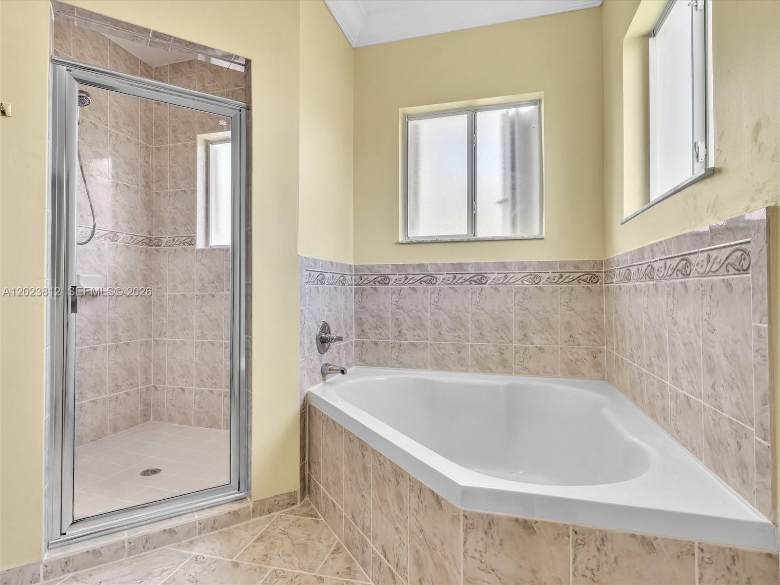 2864 Southwest 138th Path Miami, FL 33175 - Photo 25 of 40 a white bath tub sitting next to a shower