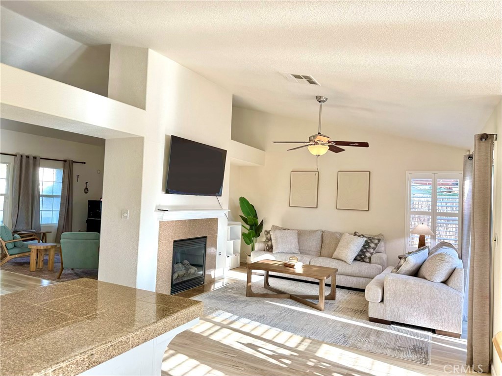 2709 Big Sandy Avenue Merced, CA 95348 - Photo 21 of 51 a living room with furniture a fireplace and a flat screen tv