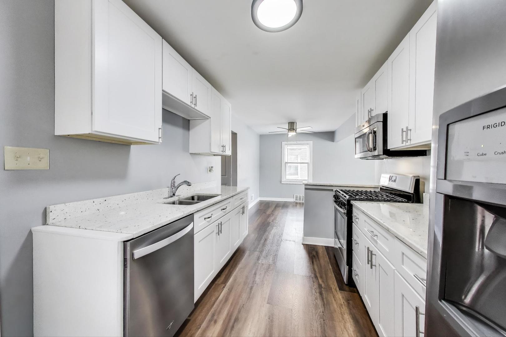 4118 Prairie Avenue Brookfield, IL 60513 - Photo 12 of 43 a kitchen with stainless steel appliances granite countertop a sink stove and refrigerator