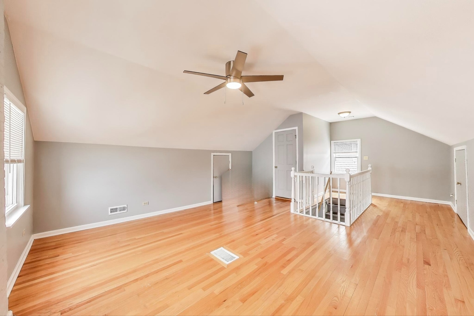 4118 Prairie Avenue Brookfield, IL 60513 - Photo 23 of 43 a view of a room with wooden floor and a ceiling fan