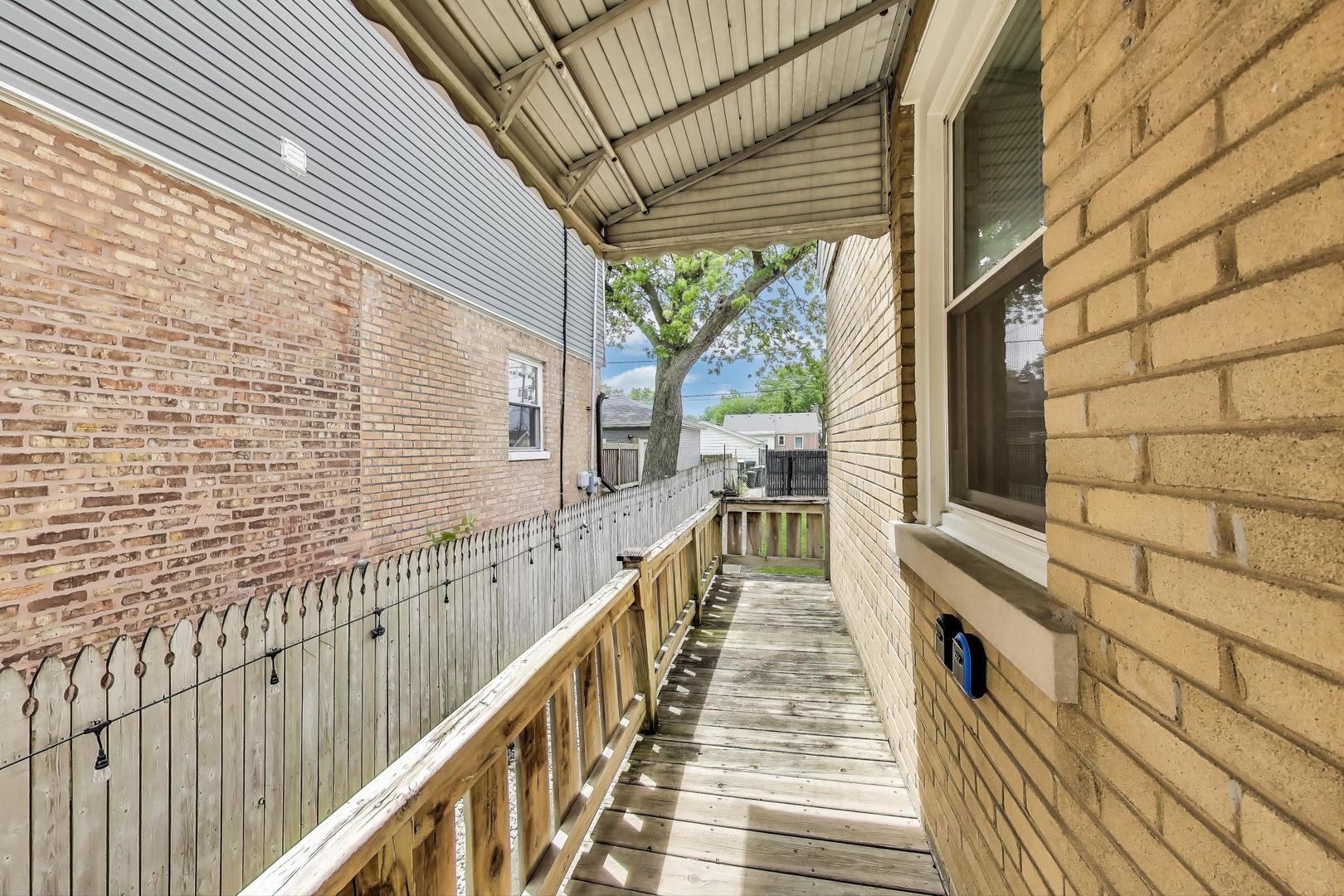 4118 Prairie Avenue Brookfield, IL 60513 - Photo 34 of 43 a view of a balcony with wooden floor and stairs