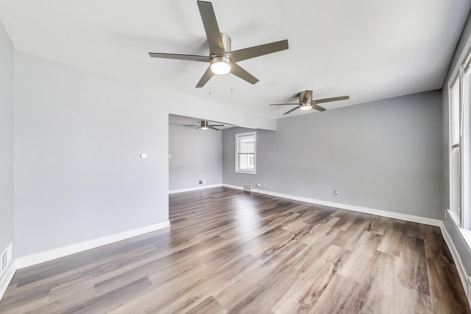 4118 Prairie Avenue Brookfield, IL 60513 - Photo 4 of 43 an empty room with wooden floor fan and windows