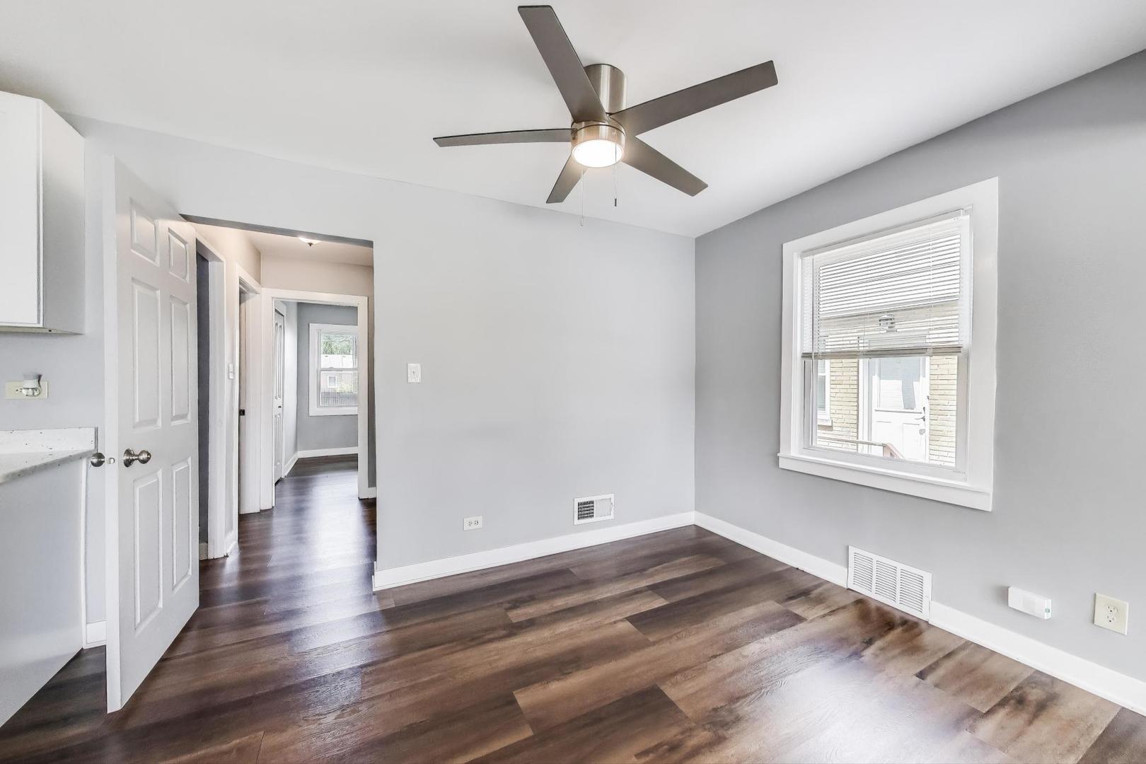 4118 Prairie Avenue Brookfield, IL 60513 - Photo 7 of 43 an empty room with wooden floor and windows
