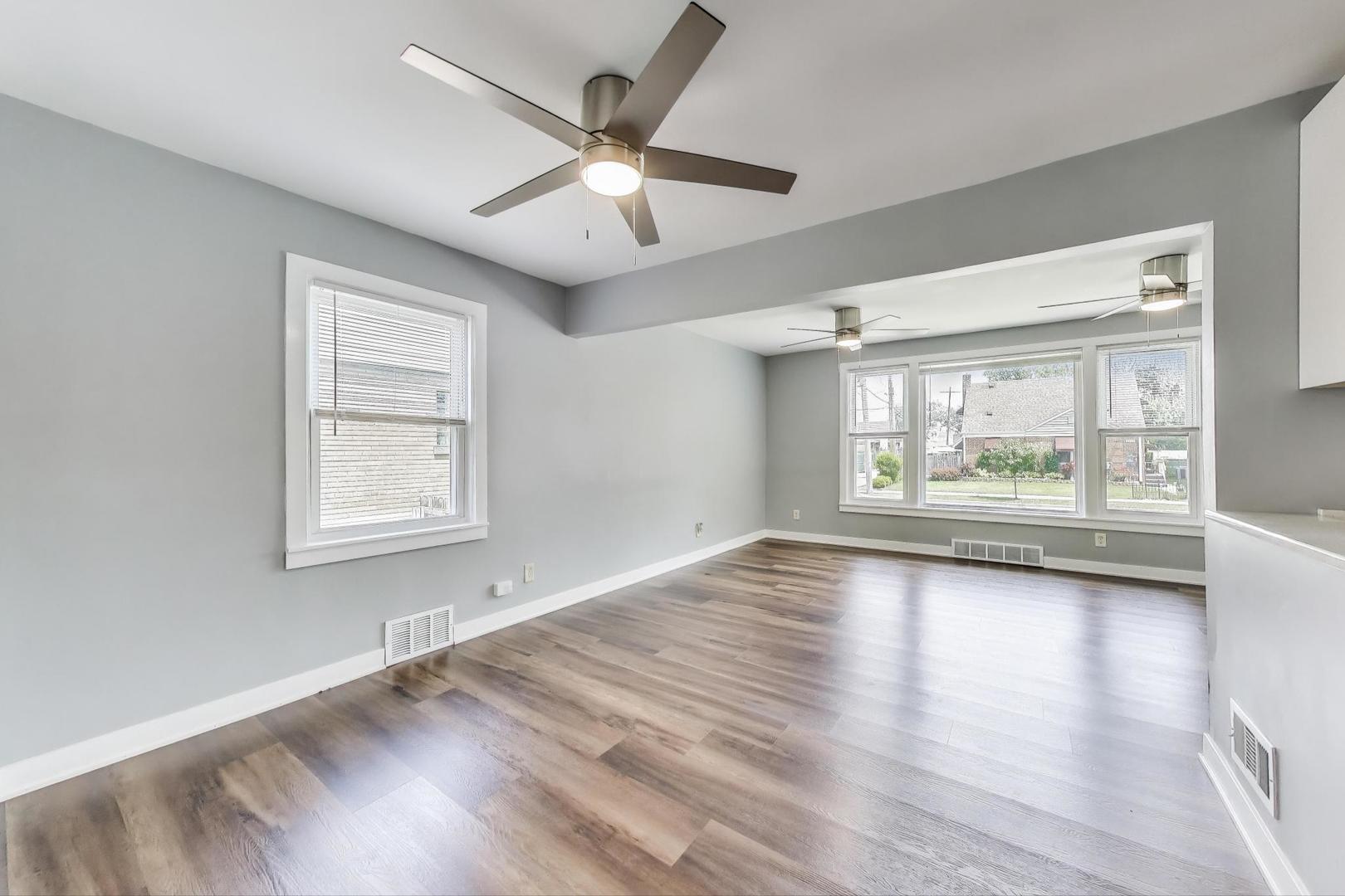 4118 Prairie Avenue Brookfield, IL 60513 - Photo 9 of 43 an empty room with wooden floor and windows
