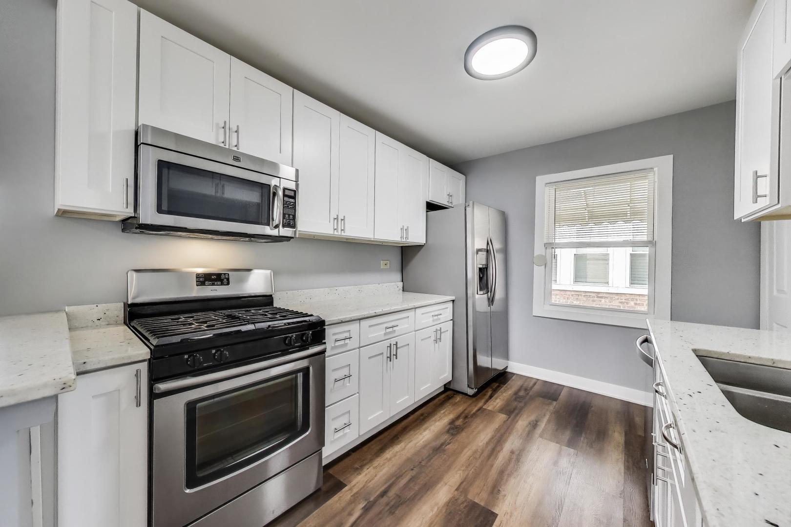 4118 Prairie Avenue Brookfield, IL 60513 - Photo 10 of 43 a kitchen with granite countertop wooden cabinets and a stove top oven