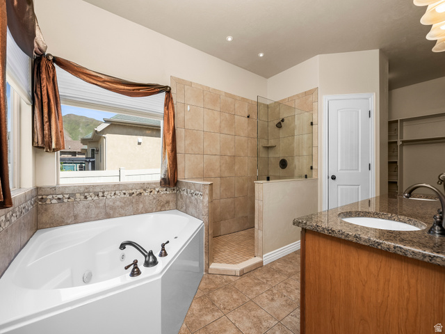 255 East 1200 North Mapleton, UT 84664 - Photo 15 of 37 Bathroom featuring a corner soaking tub with bronze fixtures, a tiled walk-in shower with a glass enclosure, and a vanity with a granite countertop and undermount sink