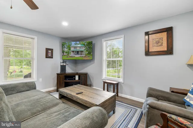a living room with furniture and a ceiling fan