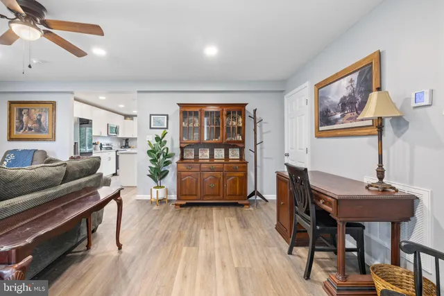 a view of a hallway with bathroom and wooden floor