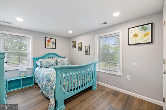 a bedroom with furniture and a wooden floor